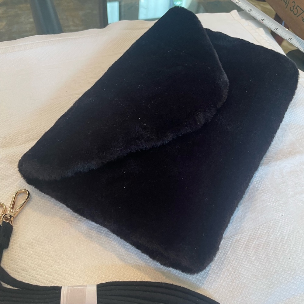 Black faux fur clutch. With strap.